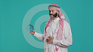 Islamic adult looks at wall clock