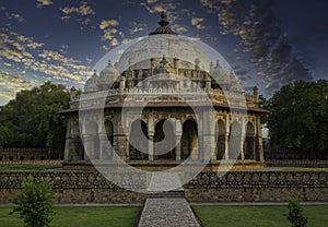 Islamic architecture tomb in Lodhi garden against dramatic sunset located in New Delhi, India