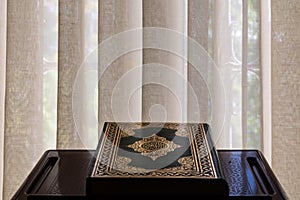 Islamic background photo. The Holy Quran on the lectern in the mosque.