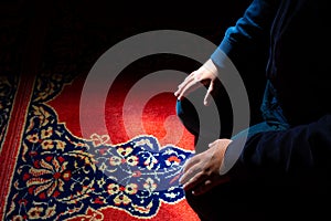 Islamic background photo. Muslim man praying in the mosque by sitting