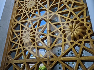 Islamic decoration in gold hue on the mosque wall, Indonesia.