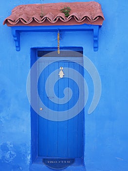 Islamic eave over door in african Chefchaouen town, Morocco - vertical