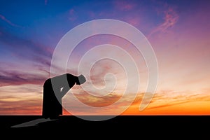 Islamic man praying Muslim Prayer in Twilight time