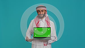 Islamic man presents greenscreen on pc