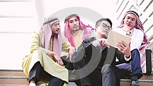 Islamic man using smartphones app organize schedule agenda  focus on hands holding smartphone muslim modern uae city. Arab men wea