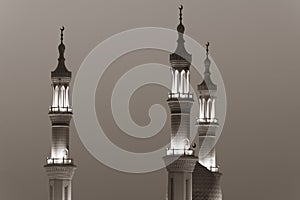 Islamic mosque spires in black and white echos prayer calls at night. Muslim, ramadan, religion concepts