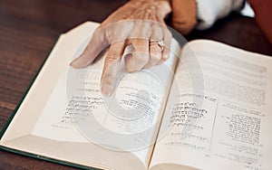 Islamic, muslim and Quran with hand of old woman reading holy book for prayer, worship or ramadan kareem celebration