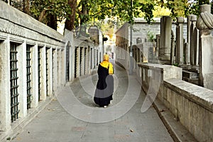 Islamic old gravestone in a cemetery and women photo