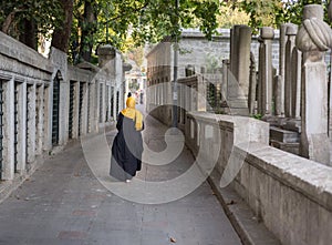 Islamic old gravestone in a cemetery and women photo
