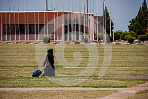 Islamic woman traveling with a case