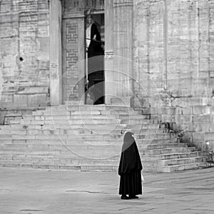 Islamic Woman waiting in front of mosque