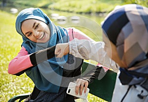 Islamic women friends fist bumps