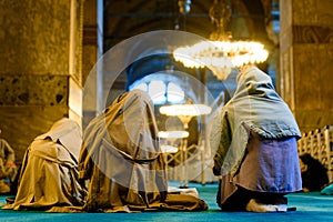 Islamic women with veil are seen praying inside a mosque in Istanbul covered with veil and kneeling