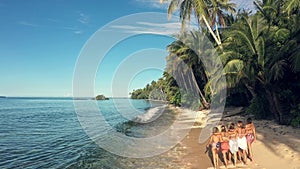 Island, aerial and women walking on beach for adventure, holiday and summer vacation in Mauritius. Traveling, relax and