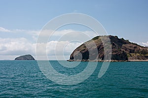 An island in the background and an outcrop at the Rosslyn Bay near Yeppoon in Capricorn area in Central Queensland, Australia