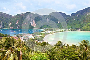Island beach, palm trees, mountains and bay with boats top view, Phi Phi Island, Thailand