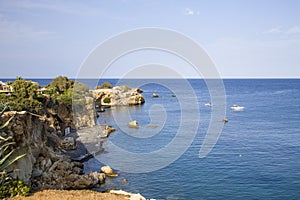 Island of Crete in Greece. Blue sea and rock on the background of the city.