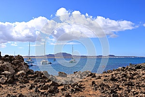 Island de Lobos, Corralejo, Fuerteventura, Spain - November 25 2023: boats mooring in front of the beach of the solitary island