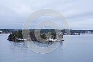 An island with a few vacation houses near Stockholm, Sweden during a cold and gloomy winter morning