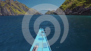 Island hopping Tour boat on speed passing exotic karst limestone strait on travel trip exploring Bacuit archipelago, El