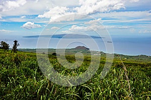 The island of Lanai in the Distance from Maui, Hawaii with sugar cane fields in the foreground.