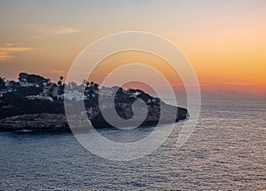 Island in the mediterranien sea during sunrise photo