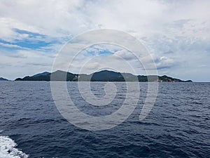 island mountain hill ferry transport ocean sea tropical gulf thailand grey sky cloud koh phangha ko samui tao dive ship