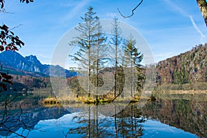 Island in a mountain lake in autumn