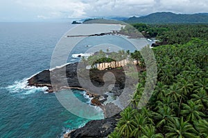 an island near a body of water surrounded by lush green palm trees, Sao Tome, Africa