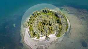 Island in ocean. Small green uninhabited beach or tiny desert island. Blue-turquoise color Gulf of Mexico water. Beautiful wildlif