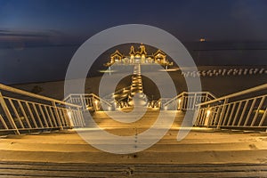 The island of RÃ¼gen in Germany, Sellin`s famous beach with the illuminated pier in the evening.