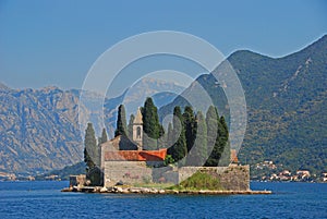 Island of Saint George Sveti Dorde, an islet off the coast of Perast in the Bay of Kotor, Montenegro mountainous background