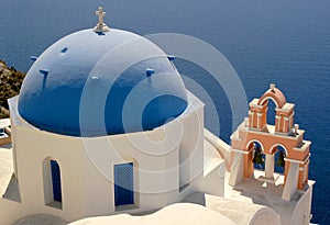 The island of Santorini offers breathtaking views over the ocean from colorful blue dome churches.