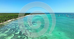 Island Saona, Dominican Republic with wild tropical beach and catamaran boats in Caribbean sea aerial panoramic view