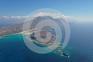 Island of Spinalonga with calm sea and mountains .Picture from above by drone