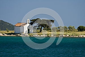 Island Sveti Justin with a small chapel photo