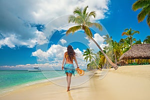 Island in the tropics. Happy walking girl enjoying tropical sandy beach, Saona island, Dominican Republic