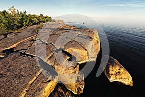 Island in Vyborg bay, aero view of clean nordic nature. Beautiful rocks and cliffs with woods in North Europe, Baltic sea, gulf of
