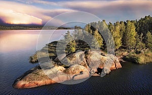 island in Vyborg bay, aero view with storm at background. Beautiful rocks and cliffs with woods in gulf of