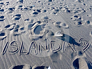 ISLANDA handwriting on black sand beach, Iceland photo