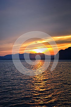 Islands Sunset, Ocean panorama views near Phuket with deep Red, Orange, Purple and Blue, mountains, twilight in Thailand. Includin