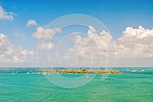 Isle land and sailboats in turquoise sea in key west, usa. Seascape with sailing boats on cloudy blue sky. Sailing and