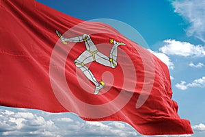 Isle of Mann national flag waving blue sky background realistic 3d illustration