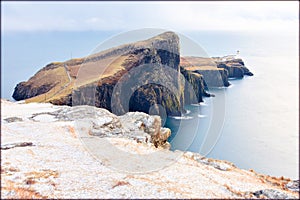 Isle of Skye winter landscape - Neist Point lighthouse and storm over ocean