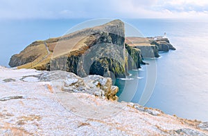 Isle of Skye winter landscape - Neist Point lighthouse and storm over ocean