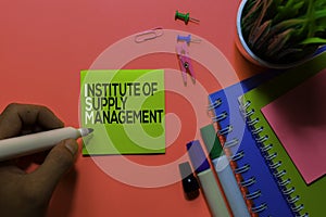 ISM. Institute of Supply Management acronym on sticky notes. Office desk background