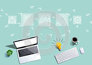 ISO 9001 concept with computers with a light bulb