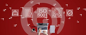 ISO 9001 concept with person working with laptop