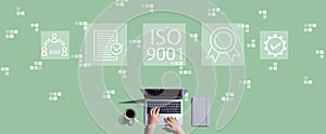 ISO 9001 concept with person working with laptop