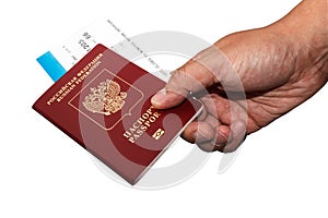 Isoalted Russian passport in hand with boarding pass